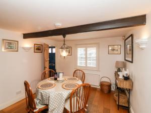 a dining room with a table and chairs at Cobblers Cottage, Southwold in Southwold