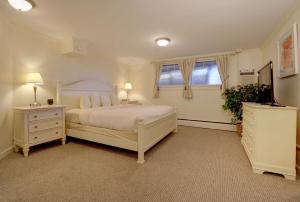 a bedroom with a white bed and a window at Senator Inn & Spa in Augusta