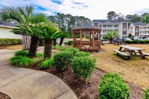 a park with a wooden gazebo and a picnic table at Our Beach House Retreat in Myrtle Beach