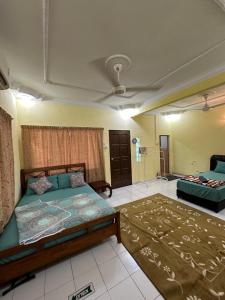 a bedroom with a bed and a ceiling at AllOfUs GuestRoom in Kuala Lumpur