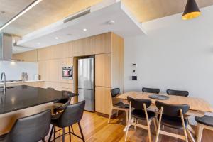 a kitchen and dining room with a wooden table and chairs at Fantastic 3-Bed Home by Melbourne Uni & Zoo in Melbourne