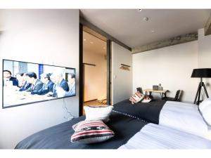 a bedroom with a flat screen tv on the wall at Volcano - Vacation STAY 89665 in Kagoshima