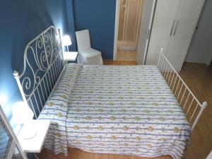 a bedroom with a bed with a blanket on it at Vista sul Tevere in Rome