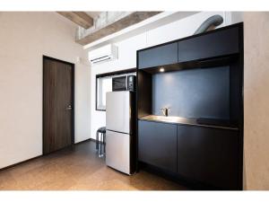 a kitchen with a refrigerator and a sink at Volcano - Vacation STAY 89674 in Kagoshima