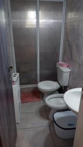 a bathroom with two toilets and a shower at vito house in Pinamar