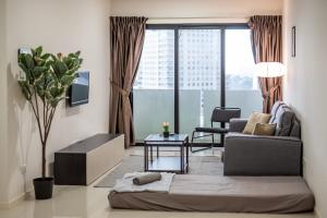 a living room with a couch and a table at A Lovely & Comfy Suite at Suasana Suites JB 11 in Johor Bahru
