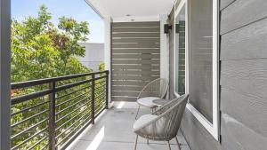 a balcony with two chairs and a railing at Landing Modern Apartment with Amazing Amenities (ID1374X218) in San Antonio