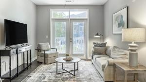 a living room with a couch and a tv at Landing Modern Apartment with Amazing Amenities (ID1286X424) in Chapel Hill
