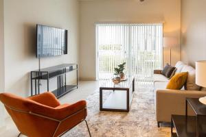 a living room with a couch and a table at Landing Modern Apartment with Amazing Amenities (ID3353) in Tampa