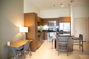 a kitchen with a table and chairs and a dining room at Landing Modern Apartment with Amazing Amenities (ID3353) in Tampa