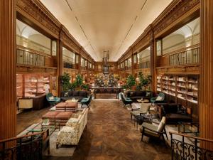 a library with couches and chairs and books at Fairmont Olympic Hotel in Seattle
