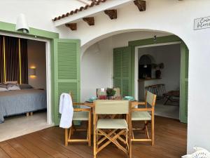 a room with a table and chairs and a bed at Apartamento nº 1 Cala Blanca in Cala Blanca