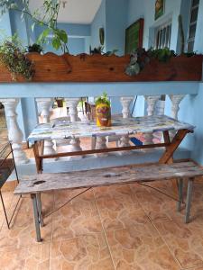 a wooden bench sitting on top of a table at POUSADA BORBOLETA AZUL in Ilha Comprida