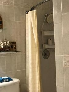 a bathroom with a shower with a white shower curtain at Perfect get away from big city life in Freeport