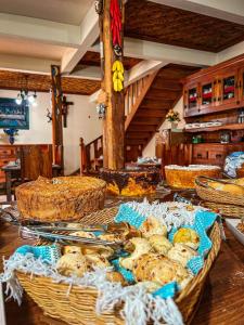 a table with baskets of food on top of it at Pousada do Gentil in Tiradentes +27 photos