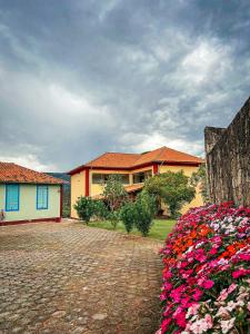a house with flowers in front of it at Pousada do Gentil in Tiradentes