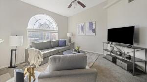 ein Wohnzimmer mit einem Sofa und einem TV in der Unterkunft Landing Modern Apartment with Amazing Amenities (ID7793X62) in Greenwood Village