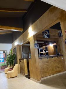a lobby with a wooden wall in a building at Posada del Lago in Villa Carlos Paz