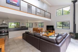 a large living room with a couch and a table at The Palm Farm in Smiths Lake