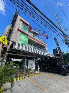 a restaurant with a truck parked in front of a building at Italy Condotel Darasa in Tanauan