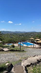 a couple of swimming pools in a field at Cabañas Terrazas del Sol in Villa Carlos Paz