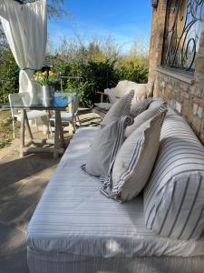 a bed sitting on a patio with pillows on it at mikipongTWO in Montepulciano +41 photos