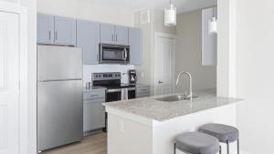 een witte keuken met een wastafel en een koelkast bij Landing Modern Apartment with Amazing Amenities (ID1206X872) in San Marcos