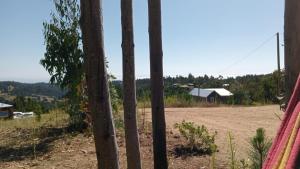 a view of a dirt field through a fence at Cabaña Familiar La Polcura in Navidad