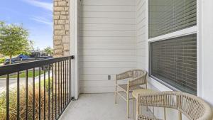 a balcony with two chairs and a window at Landing Modern Apartment with Amazing Amenities (ID1058X75) in San Antonio