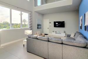 a living room with a large couch and a tv at Reunion Vacation Rental Condo 14 Community Pools! in Kissimmee
