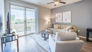 a living room with a couch and a table and a tv at Landing Modern Apartment with Amazing Amenities (ID7516X47) in Littleton