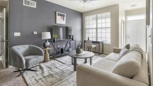 a living room with a couch and chairs and a tv at Landing Modern Apartment with Amazing Amenities (ID1174X415) in Madison