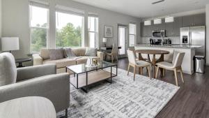 a living room with a couch and a table at Landing Modern Apartment with Amazing Amenities (ID8935X21) in Middleburg