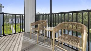 a balcony with two wooden benches on a balcony at Landing Modern Apartment with Amazing Amenities (ID8935X21) in Middleburg