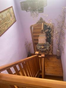 a stairway with a bench and a table with books at Double room minutes from the beach in Bexhill