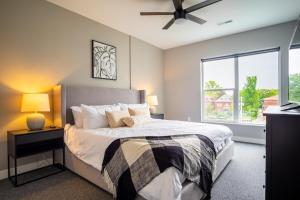 a bedroom with a bed and a large window at Landing Modern Apartment with Amazing Amenities (ID5034X58) in Tower Grove