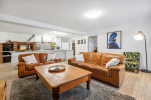 Una sala de estar con dos sofás y una mesa de café. en Winston Wallabies Urban Getaway, en Moorlands