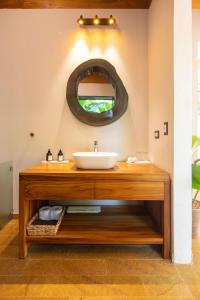 a bathroom with a sink and a mirror at El Remanso Rainforest Lodge in Puerto Jiménez
