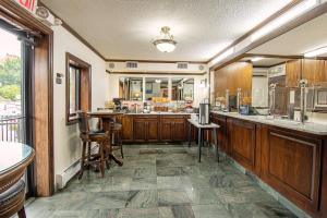 a large kitchen with wooden cabinets and a table at Holland Hotel Free Parking Jersey City in Jersey City