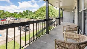 a balcony with two chairs and a view of a street at Landing Modern Apartment with Amazing Amenities (ID9665X12) in Seabrook