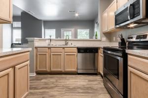 a kitchen with a sink and a stove top oven at Landing Modern Apartment with Amazing Amenities (ID5301X35) in Irving