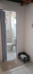 a white bathroom with a toilet and a sink at G.LO Loft AP 04 in Ponta Porã