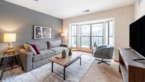sala de estar con sofá y mesa en Landing Modern Apartment with Amazing Amenities (ID1223X281) en Milwaukee