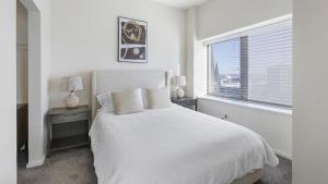 a white bedroom with a white bed and a window at Landing Modern Apartment with Amazing Amenities (ID9909X40) in Omaha