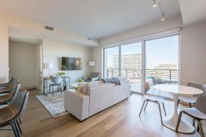 a living room with a couch and a table at Landing Modern Apartment with Amazing Amenities (ID512) in Dallas