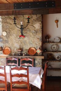 a dining room with a table and a stone wall at Hotel El Camino Real in Aquitania