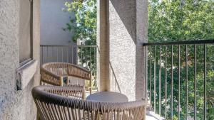 a patio with two chairs and a table on a balcony at Landing Modern Apartment with Amazing Amenities (ID1401X027) in Tucson