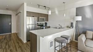 a kitchen with a counter and two bar stools at Landing Modern Apartment with Amazing Amenities (ID6509X60) in Tacoma