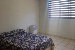 a bedroom with a bed and a window at Paulora in Hidalgo del Parral