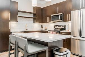 uma grande cozinha com uma grande bancada branca em Landing Modern Apartment with Amazing Amenities (ID2685X5) em Beachwood
